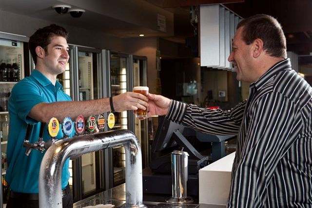 Club staff serving at the bar at The Rec Club